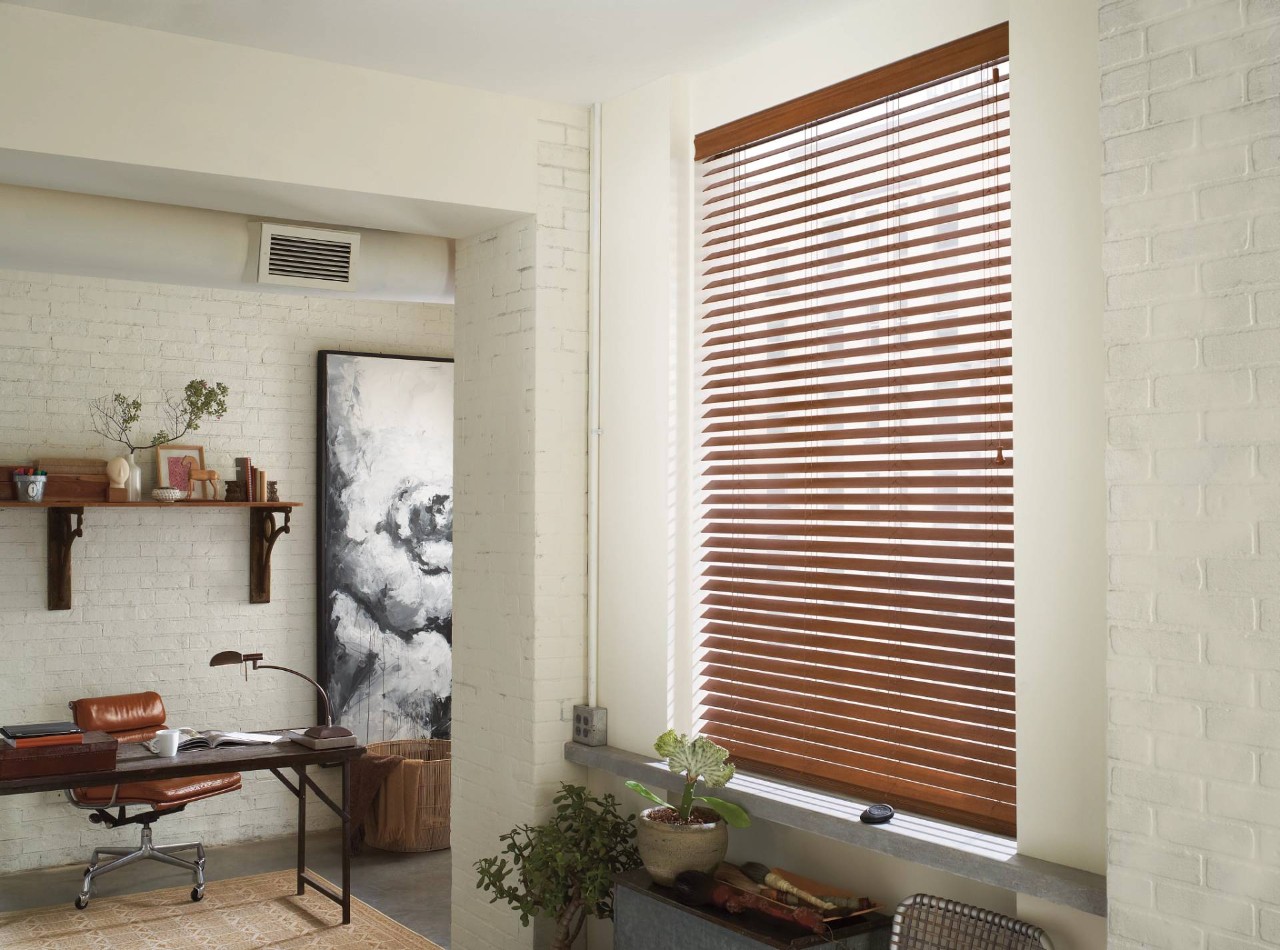 Wood window blinds blocking light in a modern home office at Don's Drapery Service near Anaheim, CA